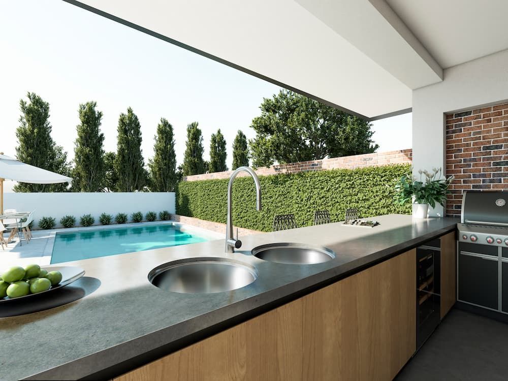 A Kitchen With Two Sinks And A View Of A Pool — Coffs Coast Designer Bathrooms in Toormina, NSW