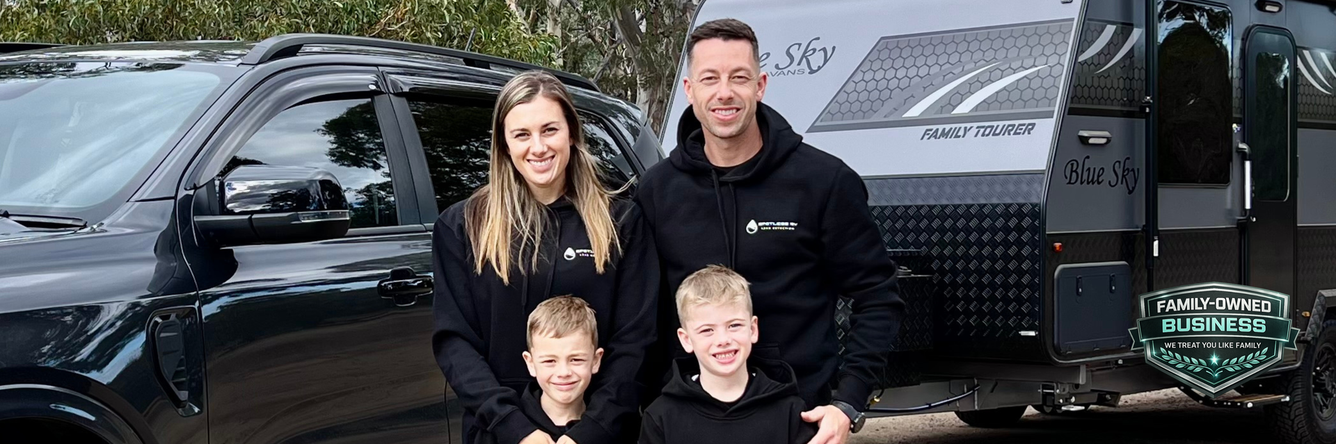 Spotless RV Leak Detection family team standing beside caravan and vehicle
