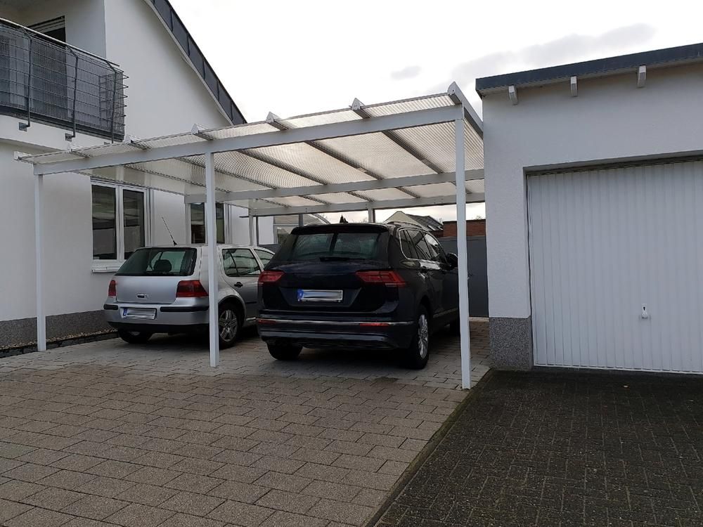 Two Cars Are Parked Under a Carport in Front of A Garage — Highline Carpentry in Kahibah, NSW
