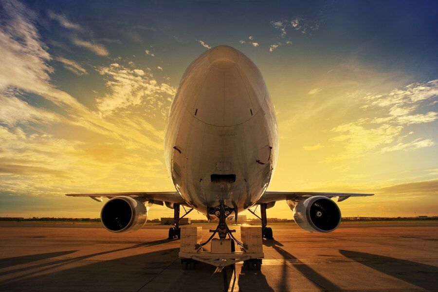 airplane with a sunset behind it