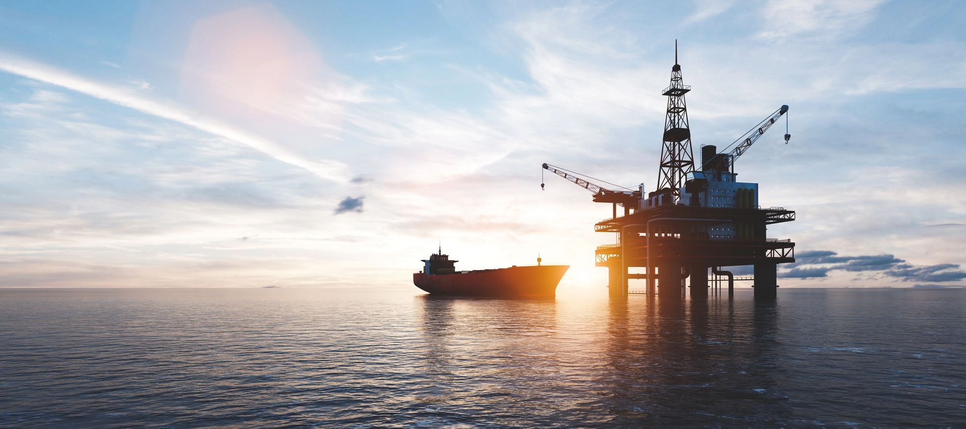 Piattaforma petrolifera offshore al tramonto con una nave.