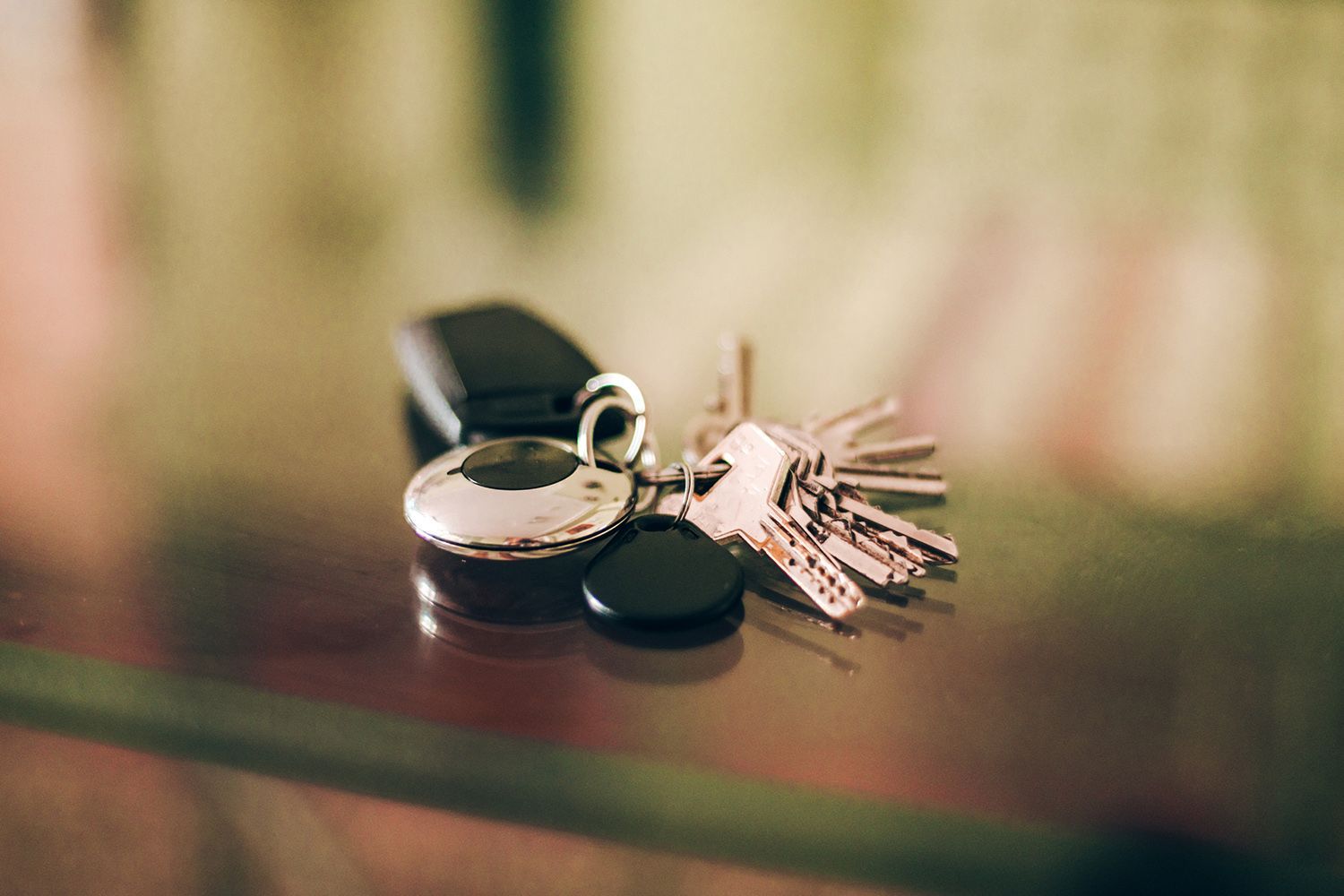 A bunch of keys sitting on top of a glass table.