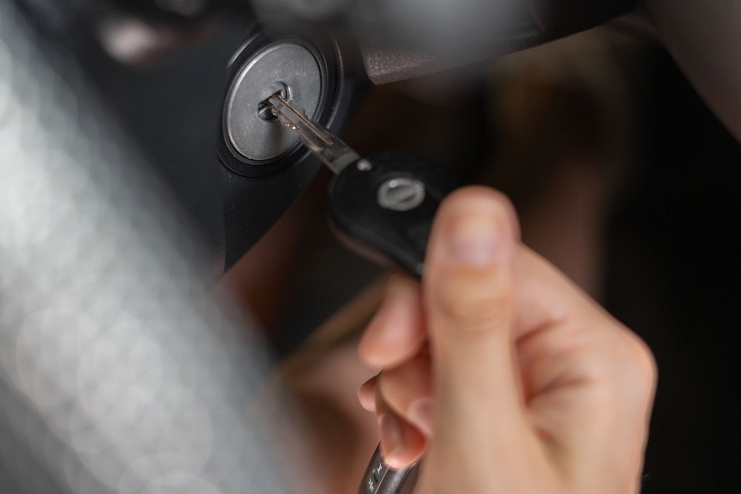 A person is holding a car key in their hand.