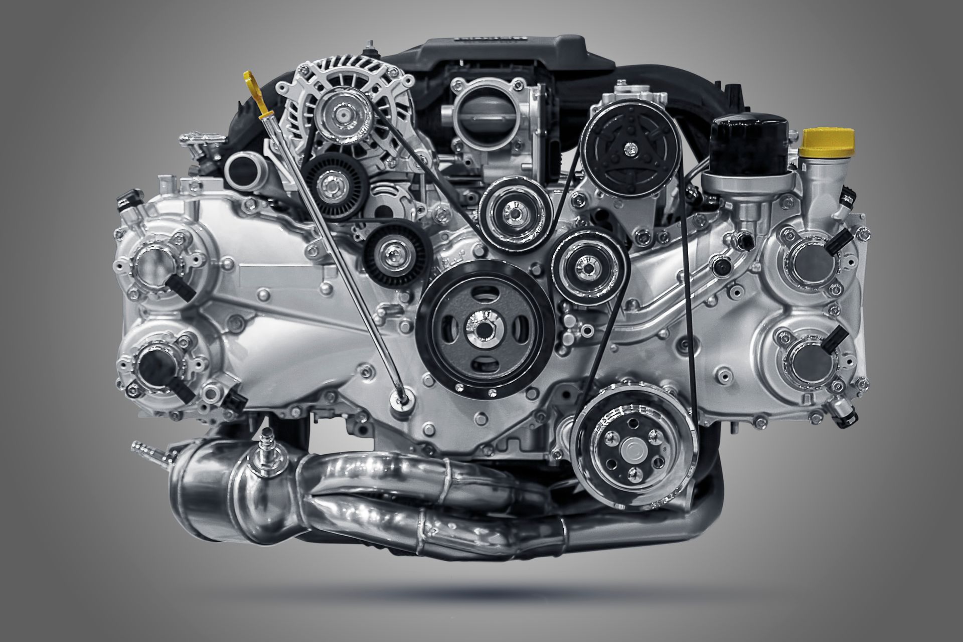 A close up of a subaru engine on a gray background.