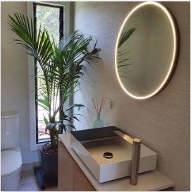A bathroom with a sink a toilet and a mirror | House Building Services | Clifton Springs
