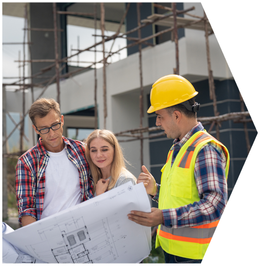A group of people are looking at a blueprint on a construction site | House Building Services | Clifton Springs
