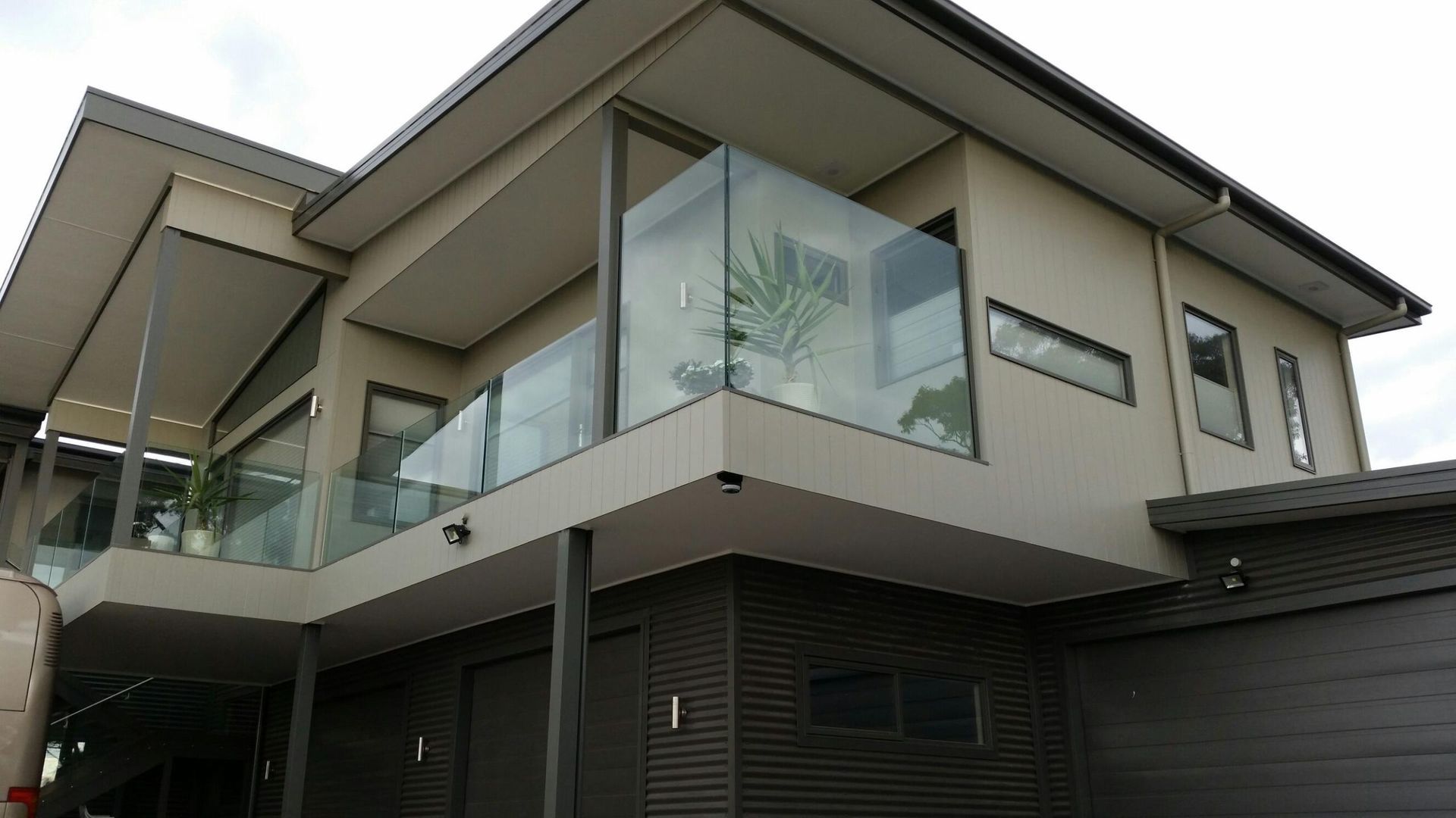 A large house with a balcony and a garage