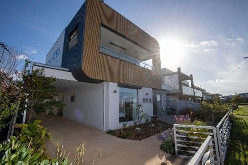View of a two-storey home in a residential neighbourhood, showcasing a custom home renovation.