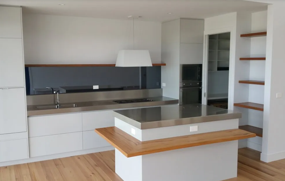 A kitchen with white cabinets and stainless steel counter tops | House Building Services | Clifton Springs