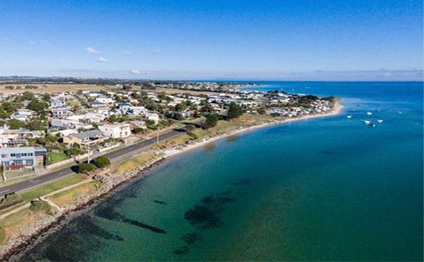 An aerial view of a city along the shore of a body of water | Indented Head