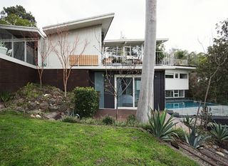 A large house with a swimming pool in the backyard  | Building Services | Coastyle