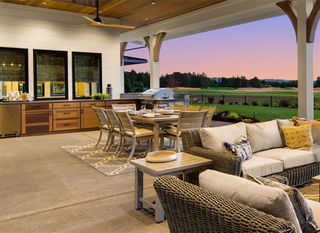 A terrace with a couch , chairs , a table and a grill  | Building Services | Coastyle