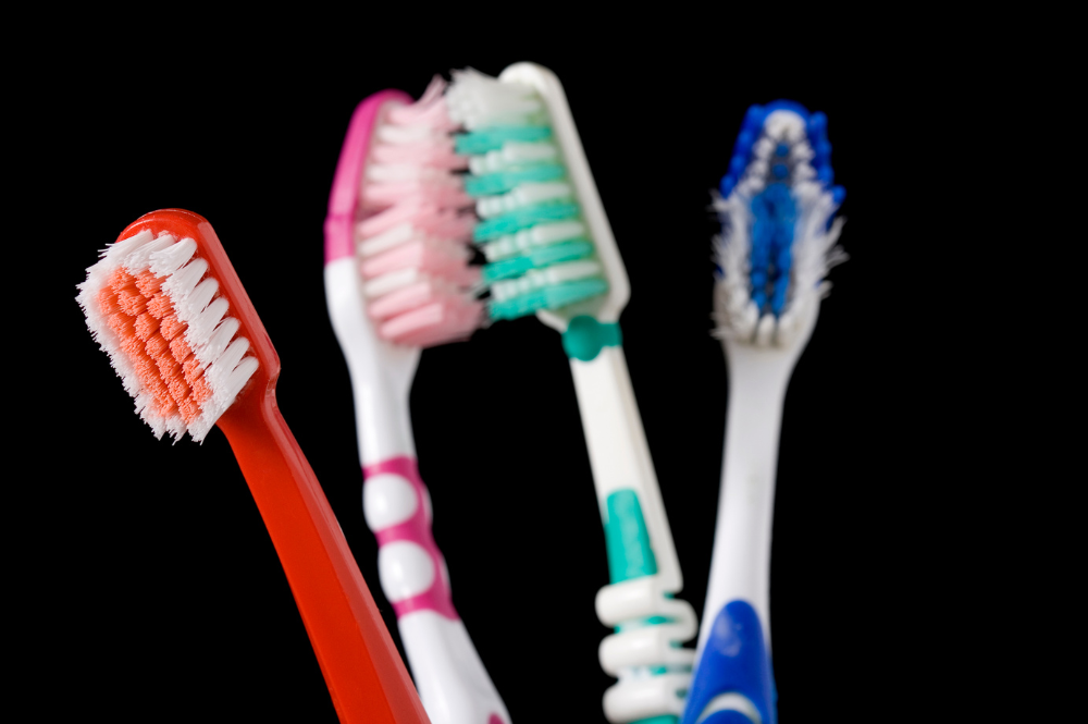 Get teeth cleaning and more at our family and pediatric dentist in Harrisburg NC. toothbrushes against a black background | Best family dentist in Harrisburg NC for teeth cleaning