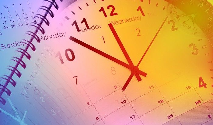Clock face overlaid on a calendar, showing time and date. Monday and Wednesday are visible.