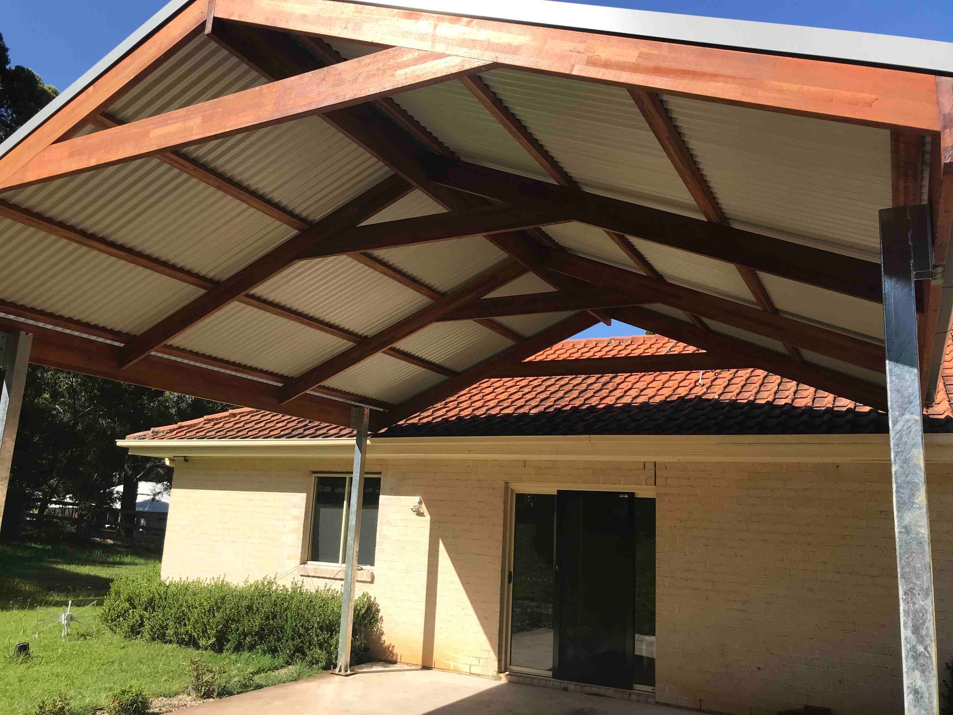 A Small Beige Building With a Red-tiled Roof — Lakecrest Projects in Belmont North, NSW