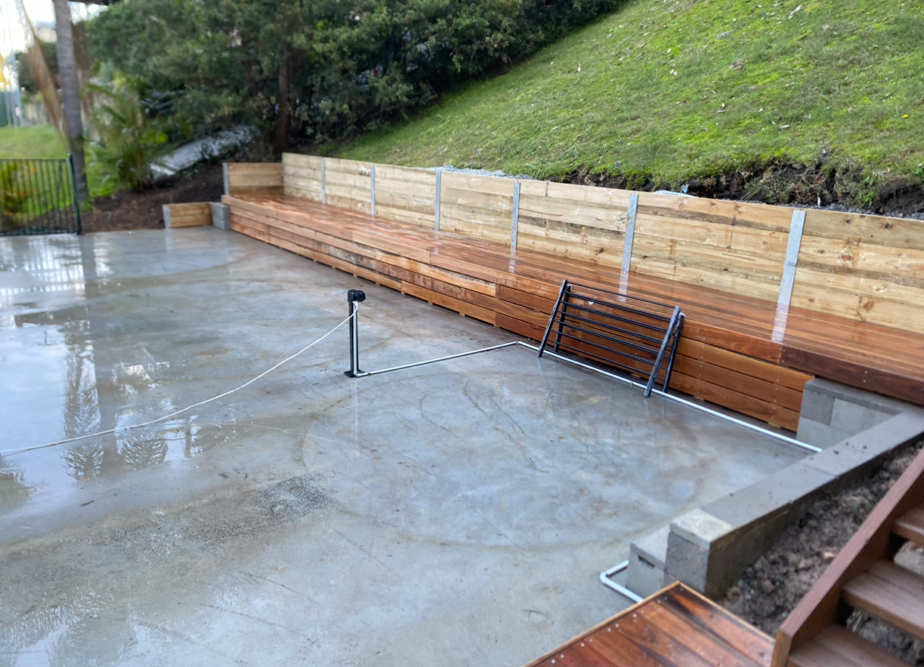 Wet Concrete Patio With Wooden Retaining Wall — Lakecrest Projects in Lake Macquarie, NSW