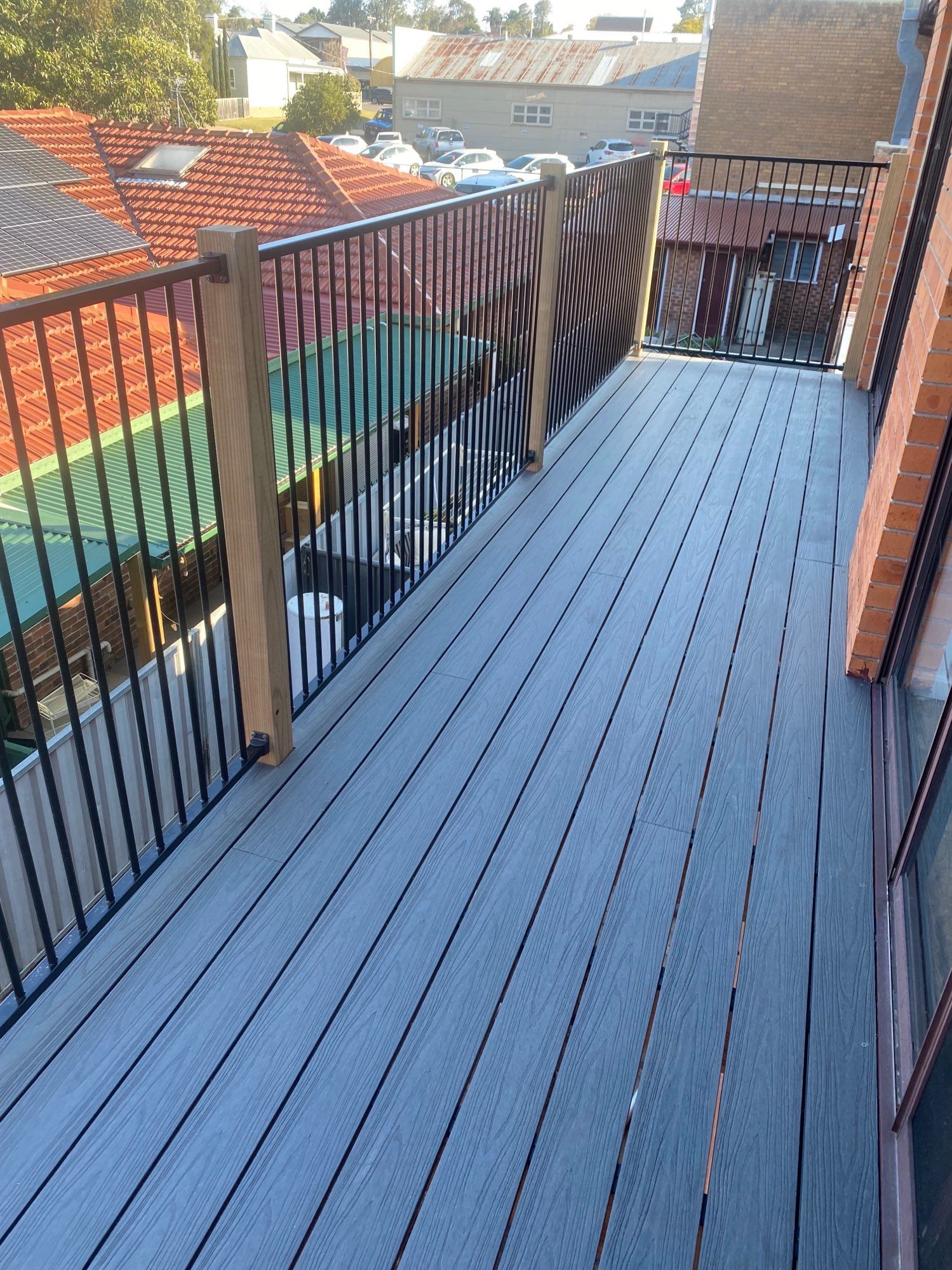 Narrow Balcony With Grey Decking — Lakecrest Projects in Belmont North, NSW