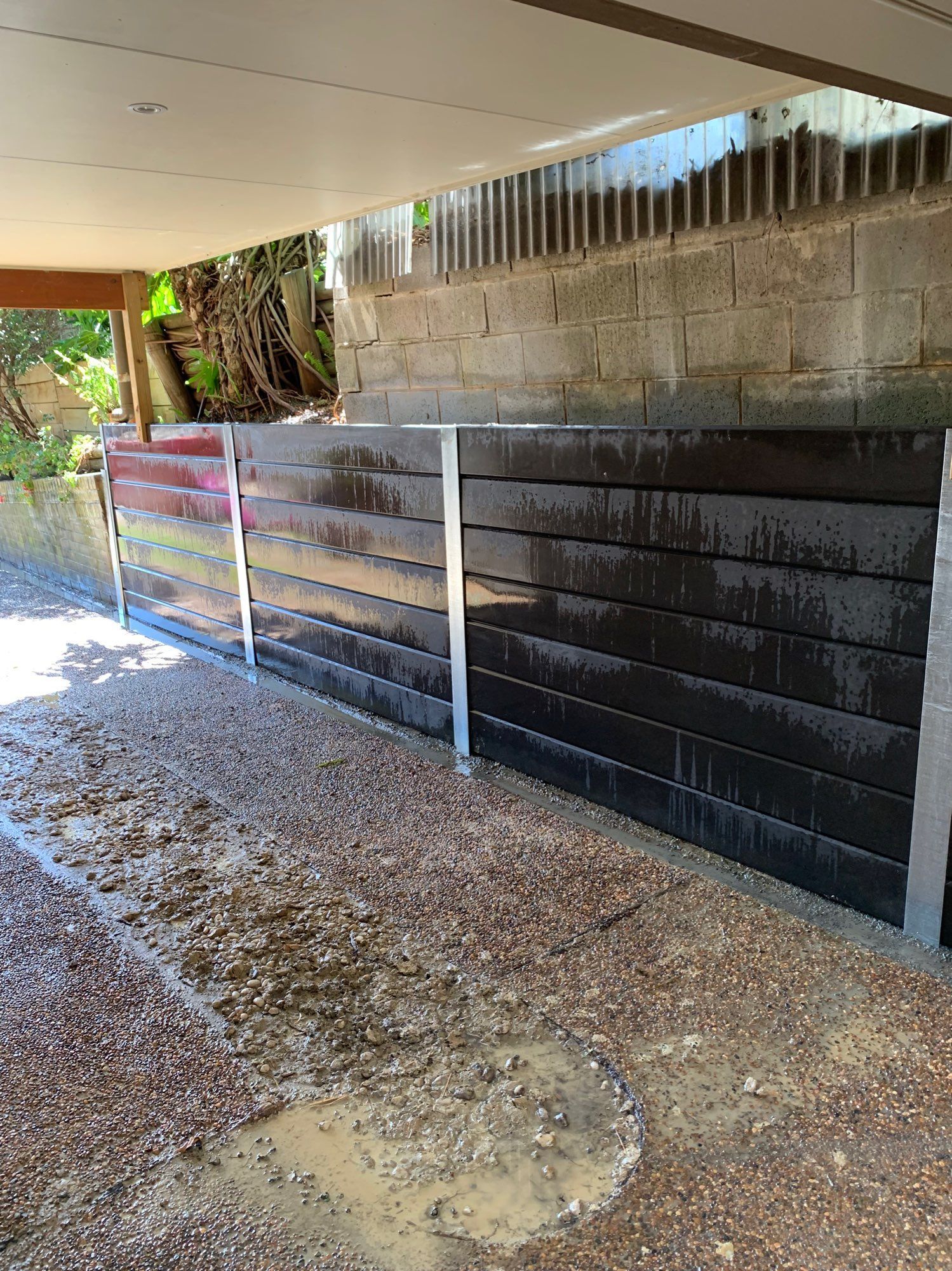 Covered Outdoor Driveway With a Black-and-white Fence — Lakecrest Projects in Belmont North, NSW