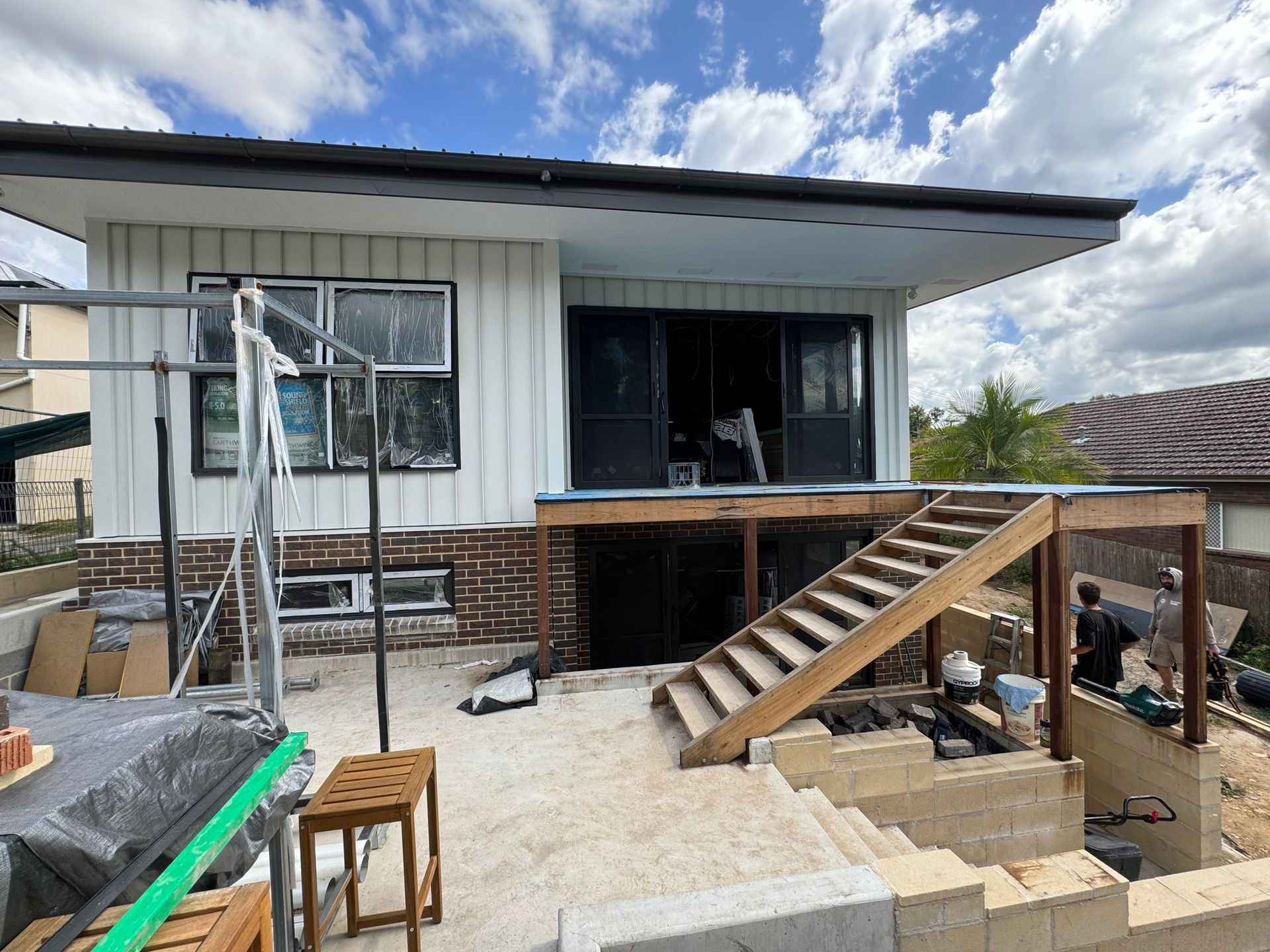 House Exterior Under Renovation With Wooden Deck Stairs — Lakecrest Projects in Belmont North, NSW