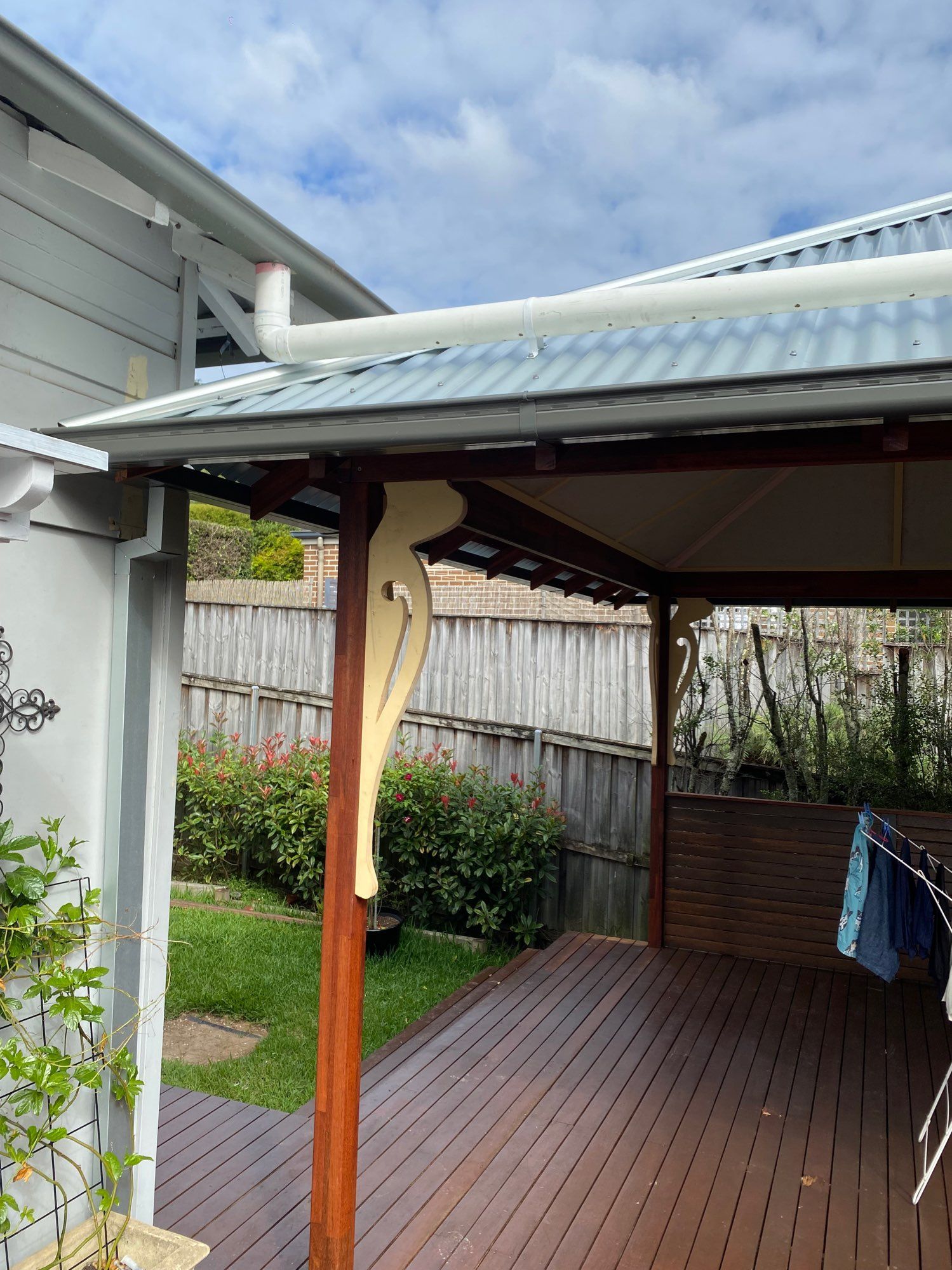 Covered Wooden Deck With a Support Post, Fence, and Garden — Lakecrest Projects in Belmont North, NSW