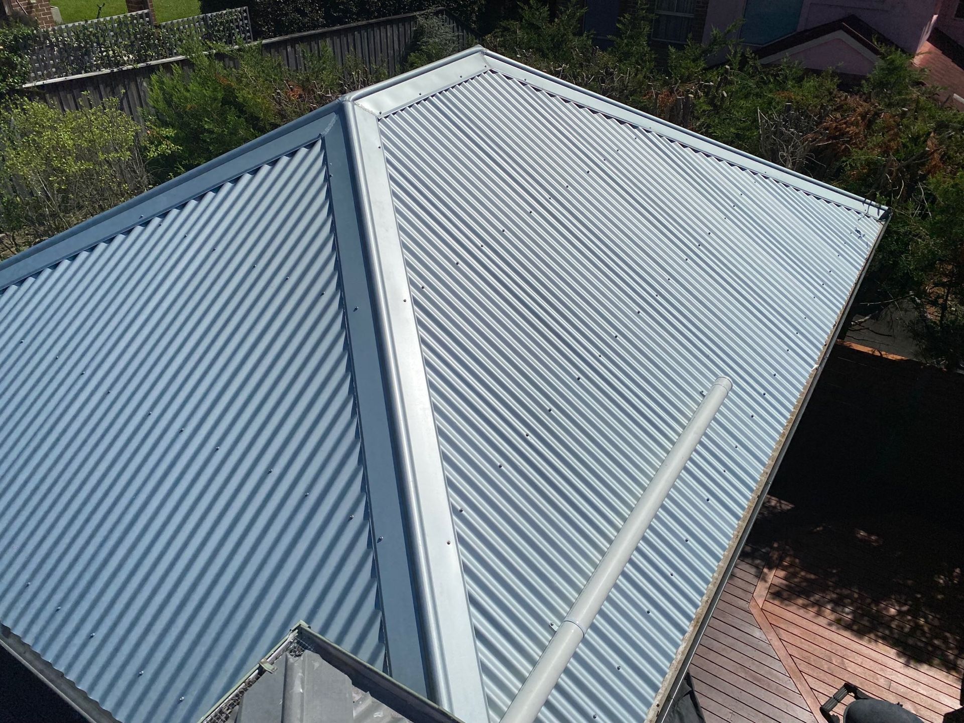 Corrugated Metal Roof With a Central Ridge — Lakecrest Projects in Belmont North, NSW