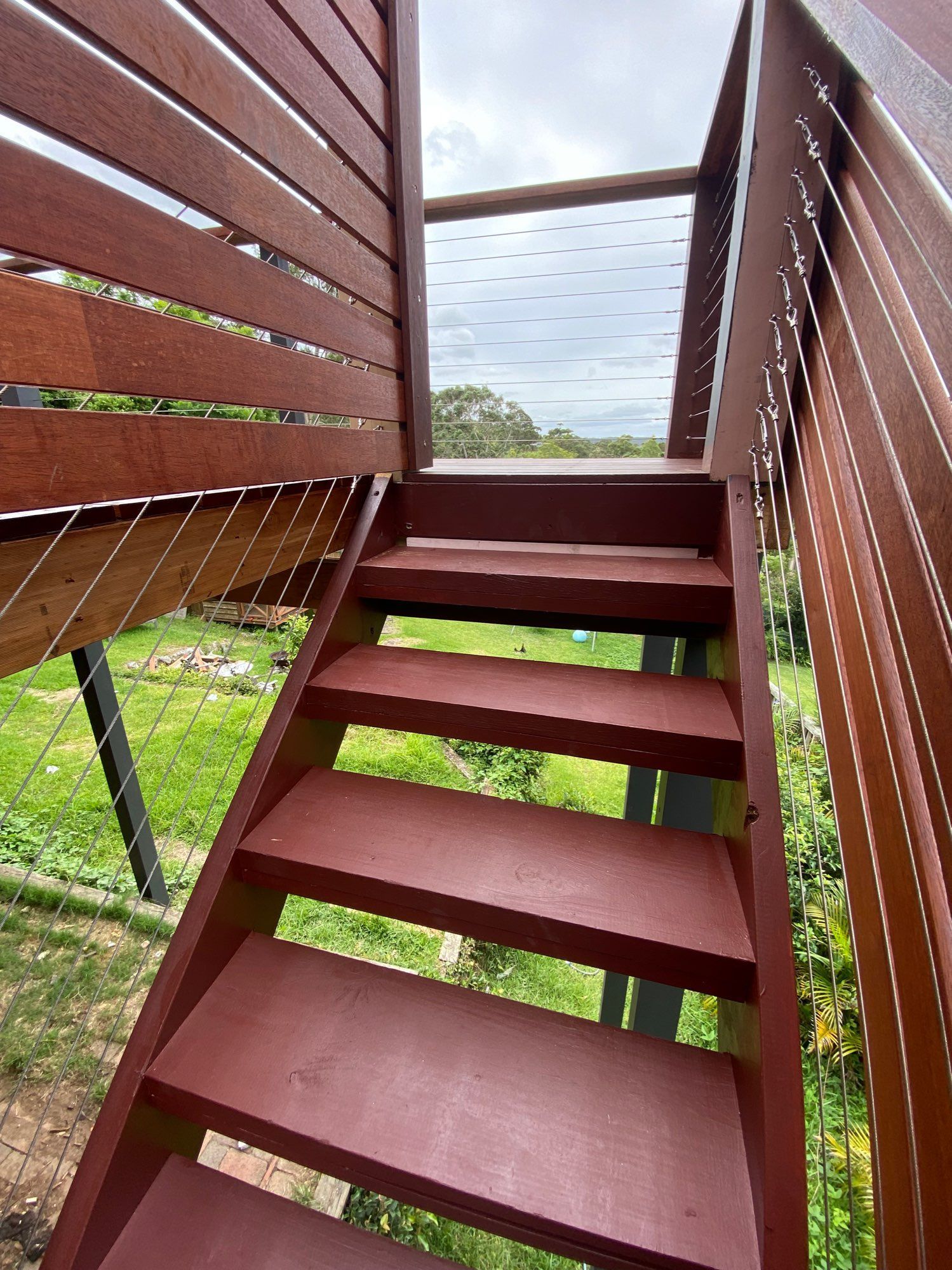 Red Wooden Outdoor Staircase With Cable Railings — Lakecrest Projects in Belmont North, NSW