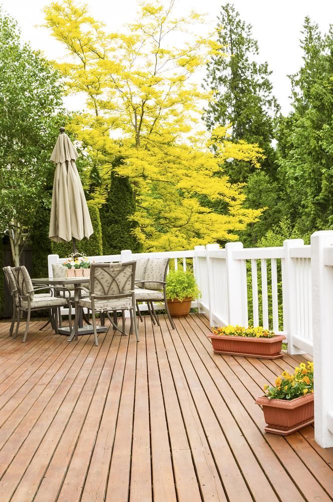 A Wooden Deck With a Table and Chairs and a White Railing — Lakecrest Projects in Hunter Valley, NSW