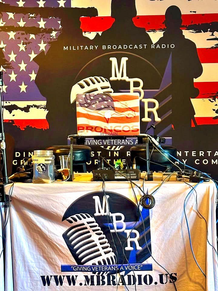 A table with a military broadcast radio sign on it