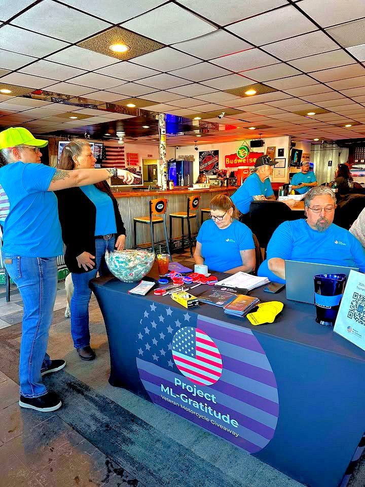 A group of people are standing around a table in a restaurant.