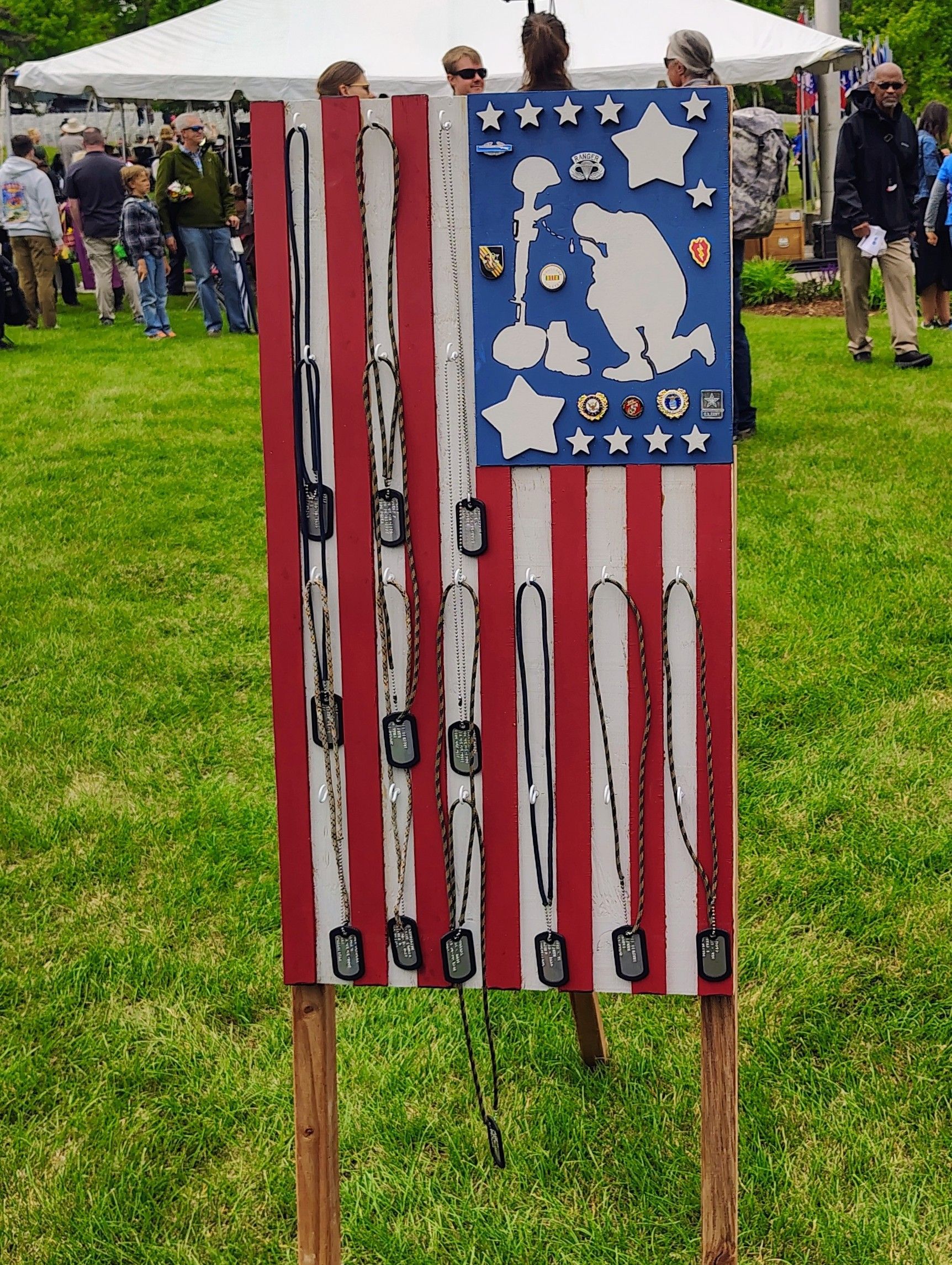 A sign that looks like an american flag with necklaces on it