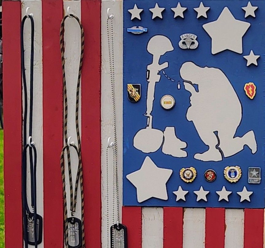 A red white and blue flag with a silhouette of a soldier on it
