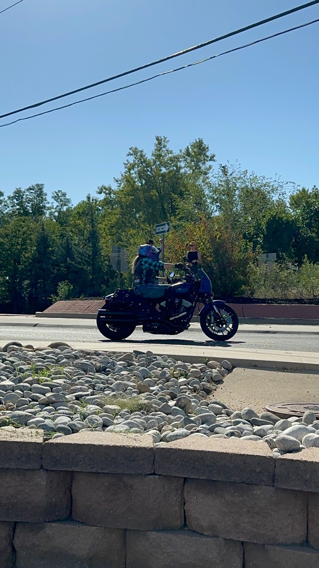 A person is riding a motorcycle down a street.