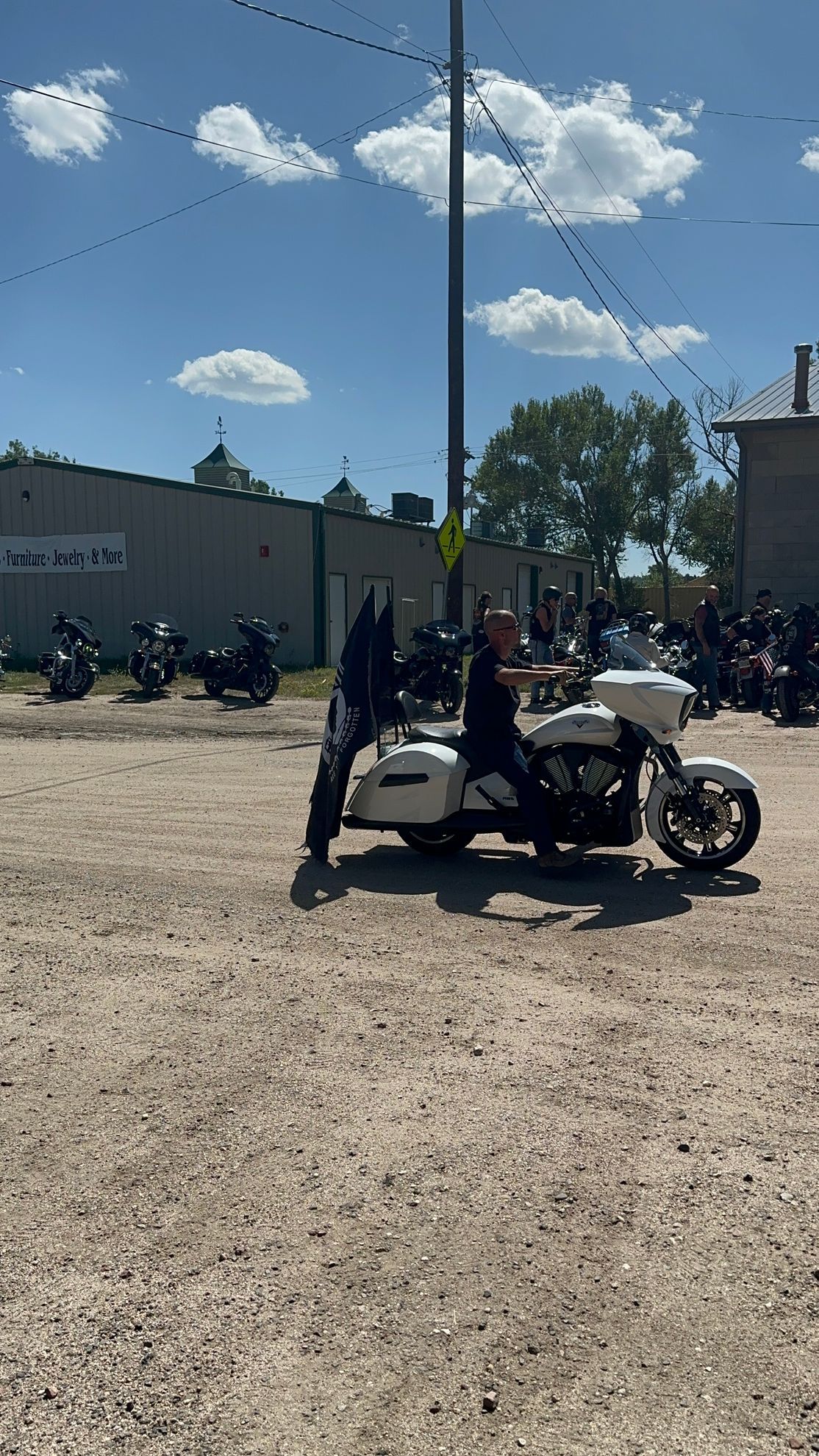 A man is riding a motorcycle in a dirt field.