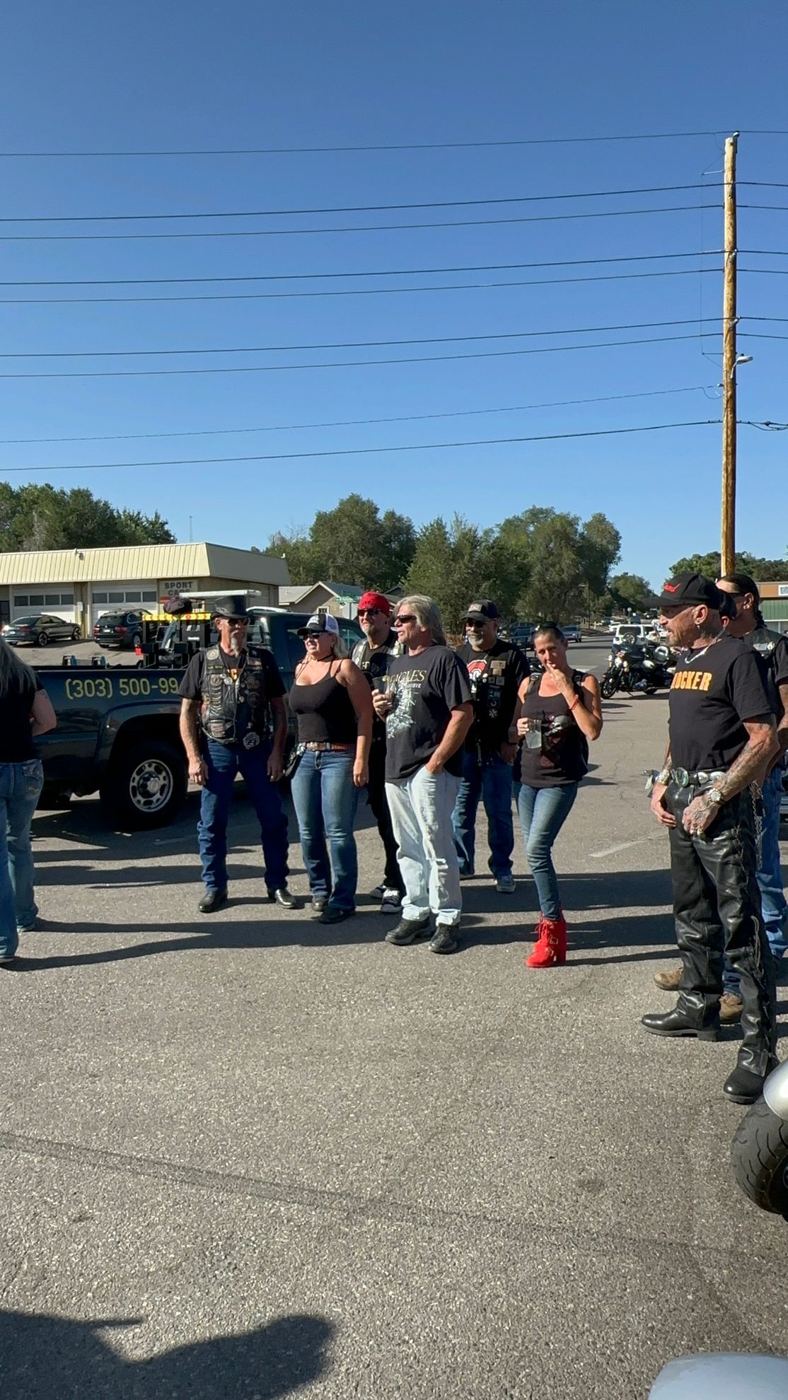 A group of people are standing in a parking lot.