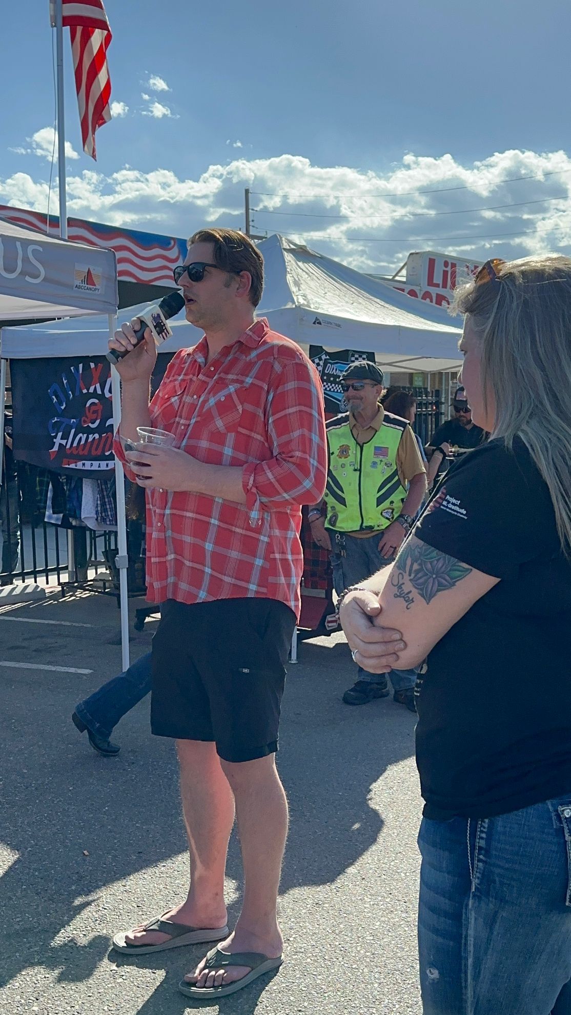 A man is holding a microphone while standing next to a woman.
