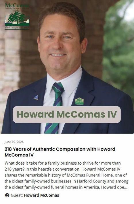 Portrait of Howard McComas IV in a navy suit with an informational card about his compassionate care campaign