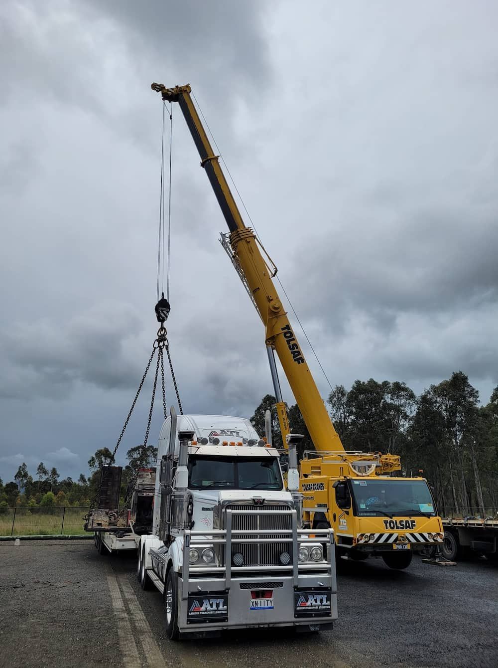 A Truck Is Being Lifted By A Large Yellow Crane — Armour Transport Logistics In Narrabri, NSW
