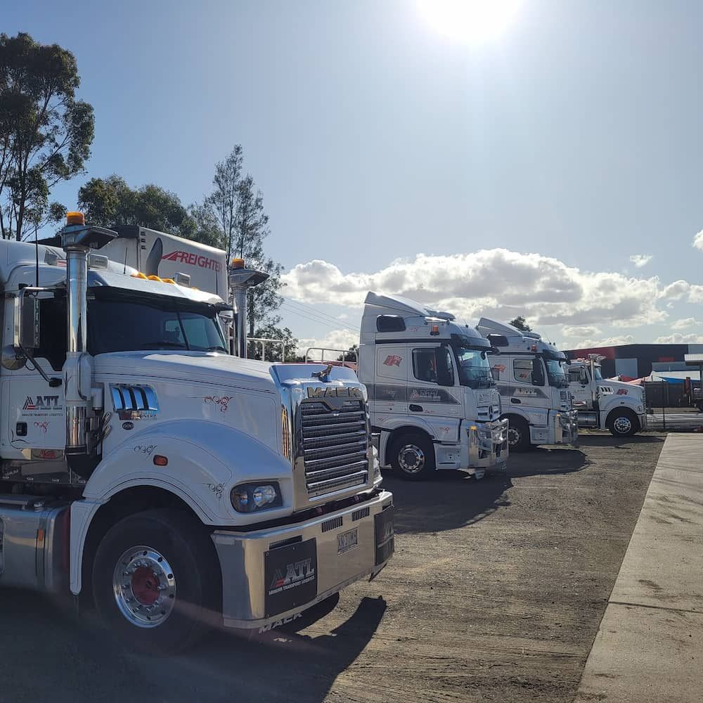 A Row Of Semi Trucks Are Parked In A Parking Lot — Armour Transport Logistics In Muswellbrook, NSW