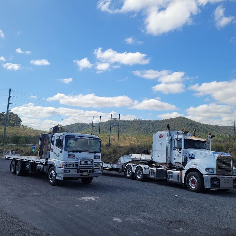 Two Semi Trucks Are Parked On The Side Of The Road — Armour Transport Logistics In Sydney, NSW
