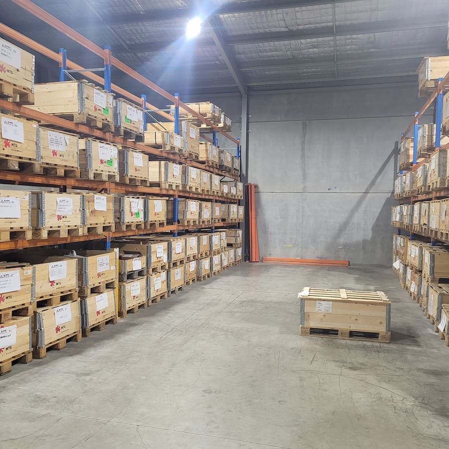 A Large Warehouse Filled With Lots Of Wooden Crates — Armour Transport Logistics In Mackay, QLD