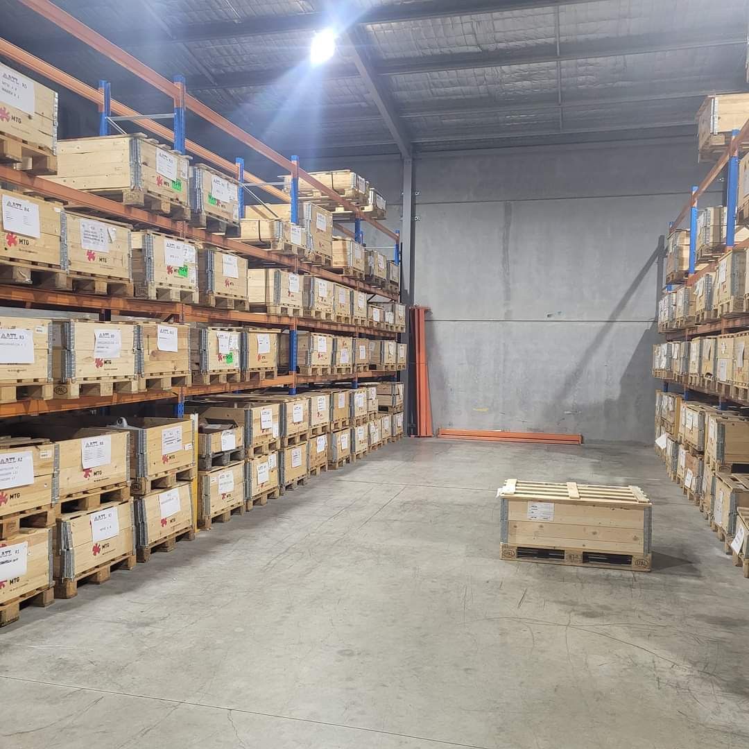 Wooden Pallets Stacked In Storage Facility— Armour Transport Logistics In Rutherford, NSW