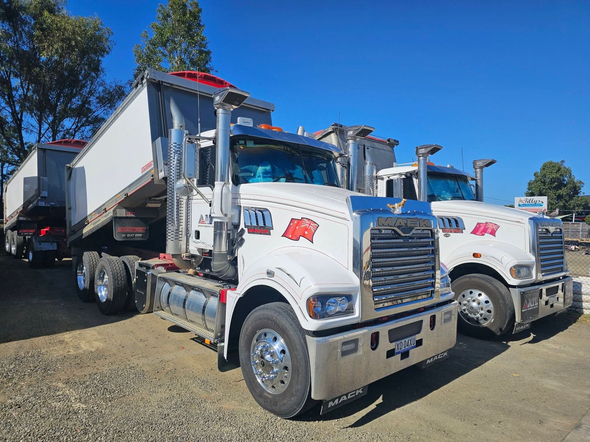 Two white semi-trucks parked side by side outdoors under a blue sky Armour Transport Logistics In Rutherford, NSW