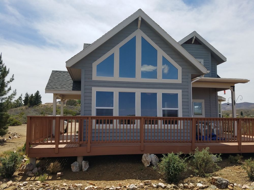 A house with a large deck and a lot of windows