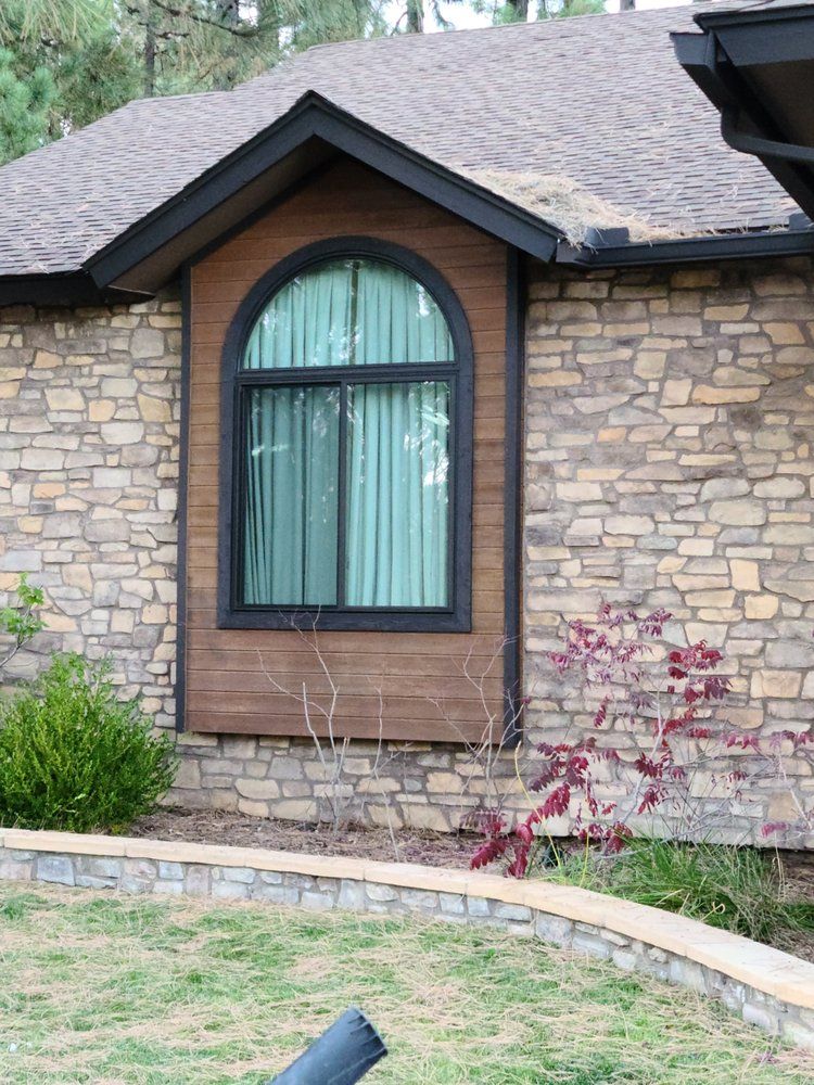 A brick house with a large arched window