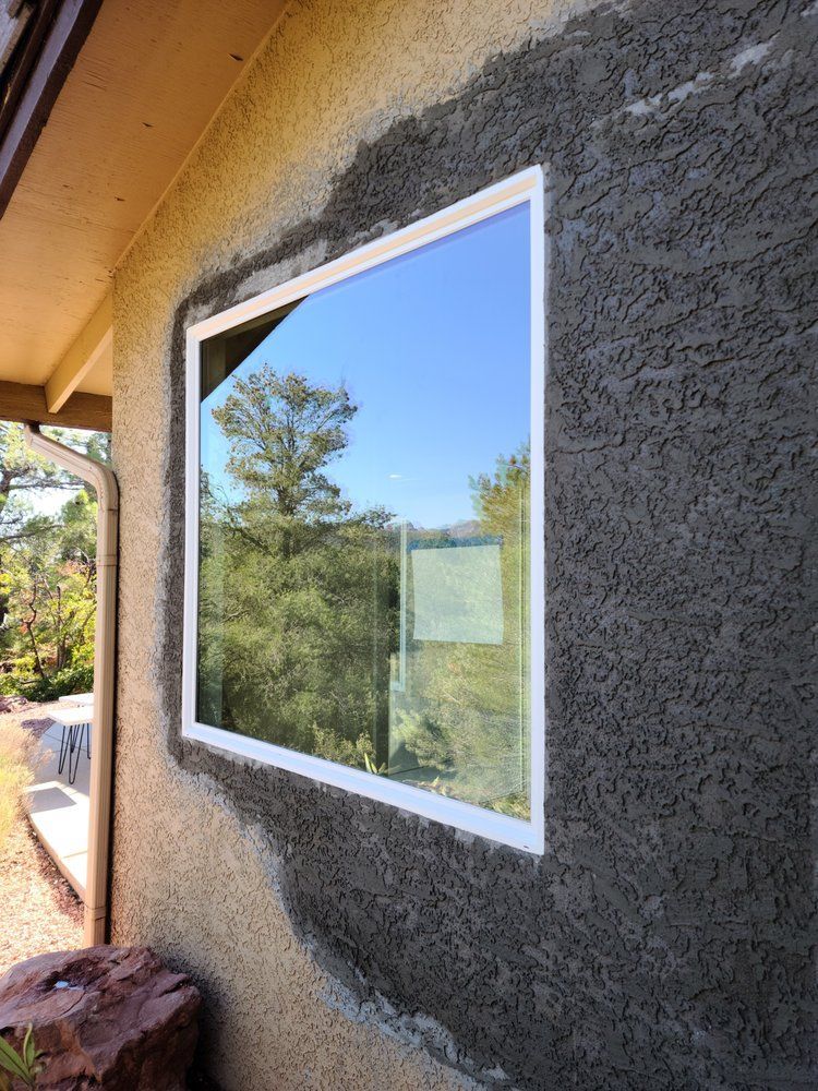 A window is being installed on the side of a house.