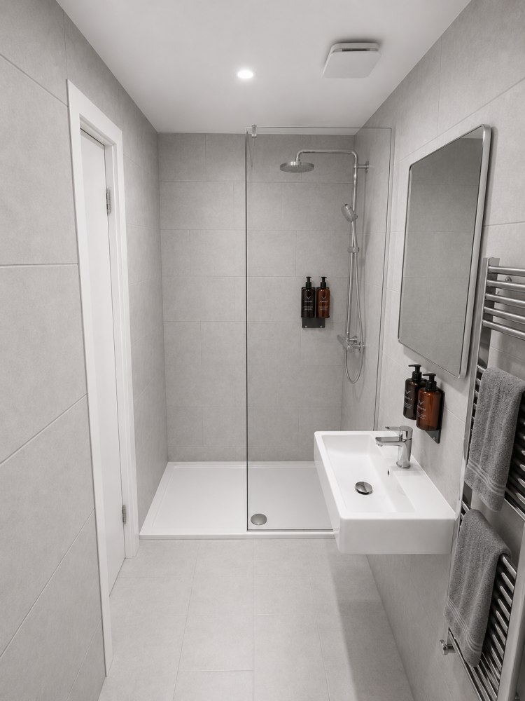 Modern white bathroom with walk-in shower, vanity sink, mirror, and towel radiator.