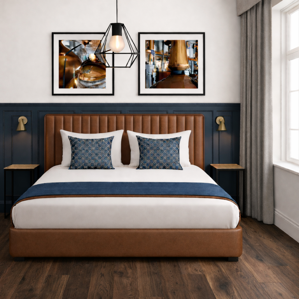 Modern bedroom with a large bed, dark blue accents, framed art, and a hanging pendant light