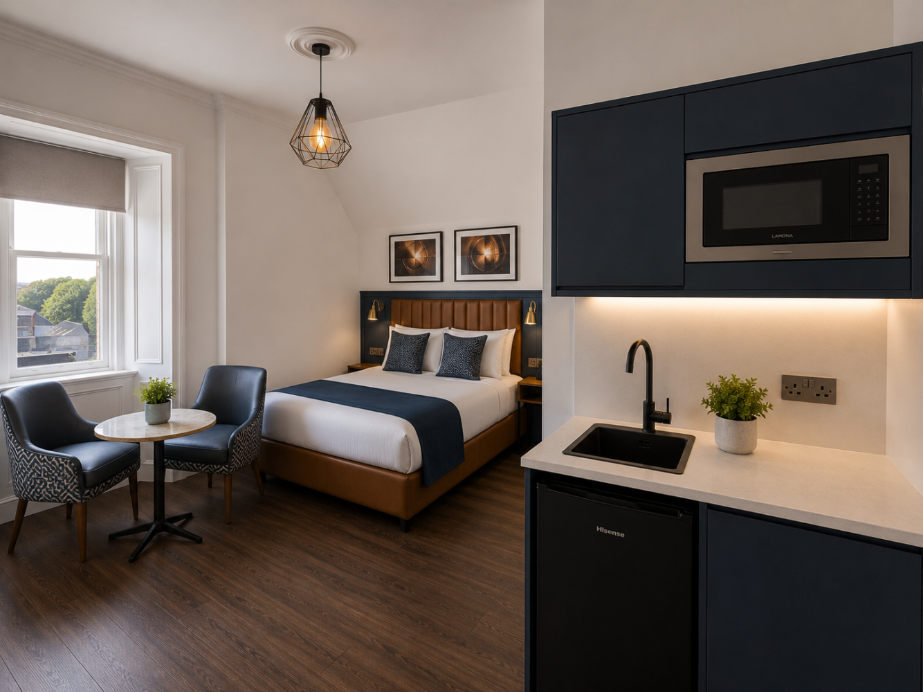 Modern studio apartment with bed, kitchenette, dining table, and large window overlooking greenery