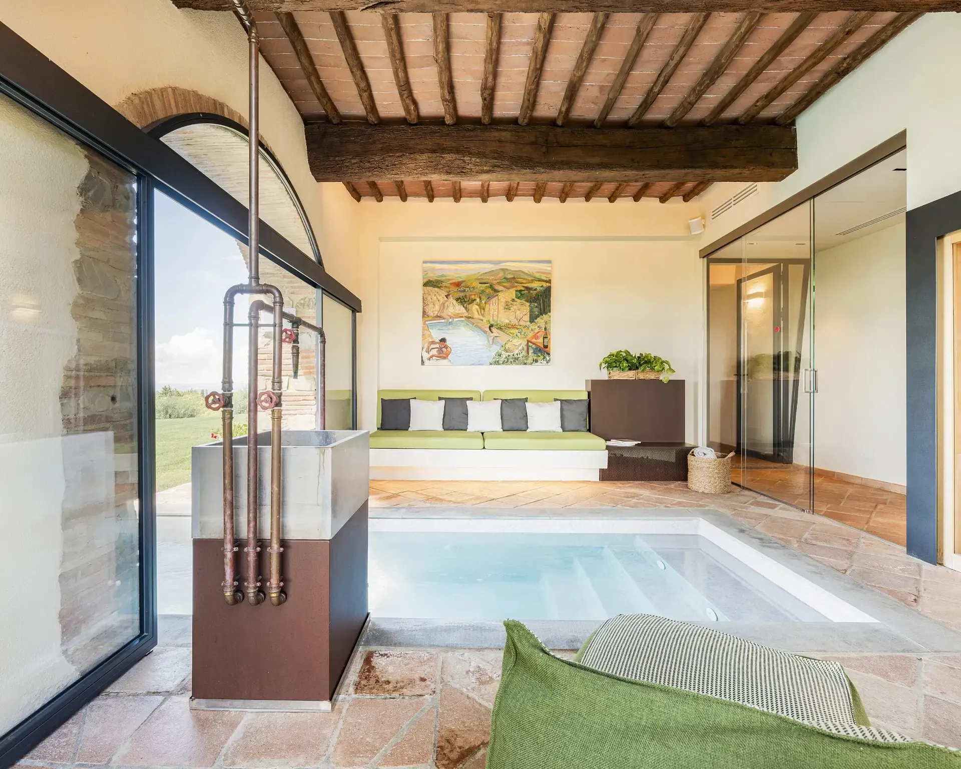 Indoor spa with a small pool, large windows, rustic ceiling, and a copper shower fixture.