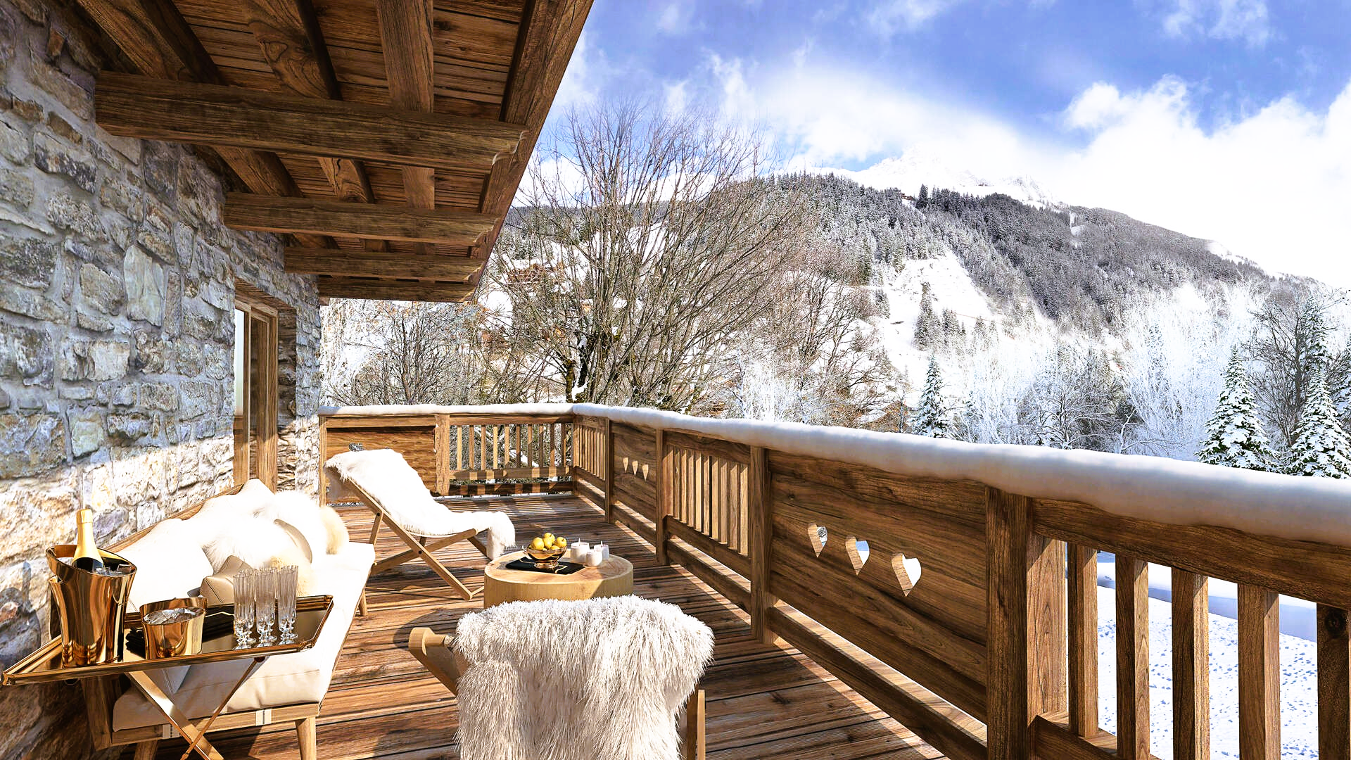 A snowy balcony overlooking a mountain, with seating, a tray, and champagne bucket.